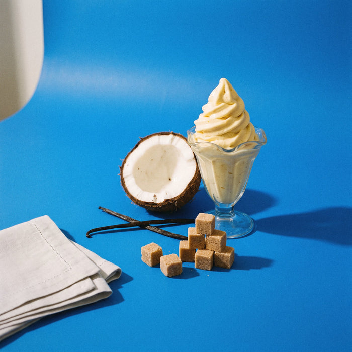 Soft Serve — vanilla custard, coconut cream and brown sugar beside a folded towel on cobalt